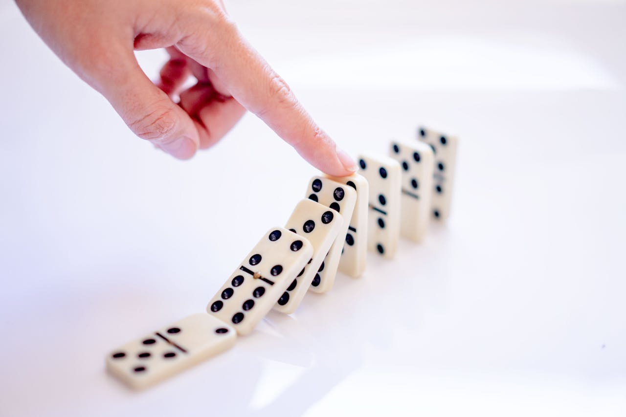 Dominosteine Metapher für Risiken der Insolvenz